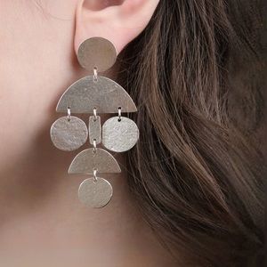 Annie Costello Brown pom pom earrings in silver